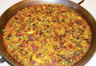Img 1: Paella of Albufera duck and locally-grown baby vegetables